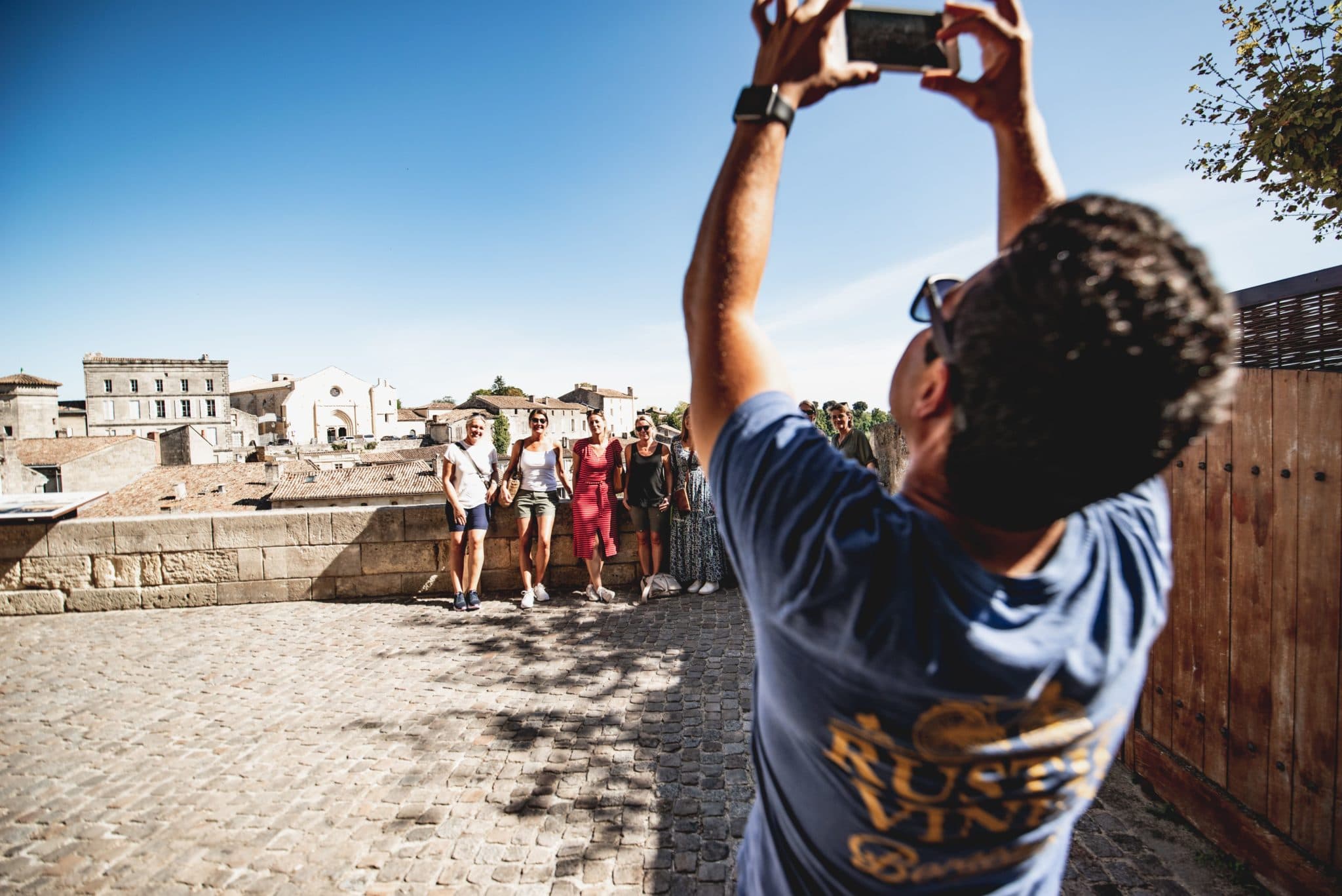 A Rustic Vines guide photographs guests above Saint-Émilion